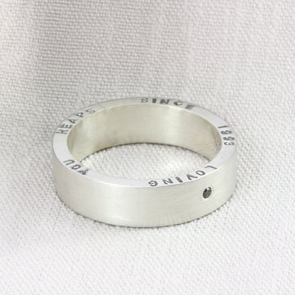 Chunky personalised sterling silver ring with black diamond, hand-stamped with custom text.