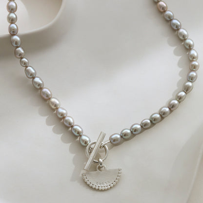 Close-up of Half Pearl and Silver Belcher Chain Fan T-Bar Necklace with personalised pendant.
