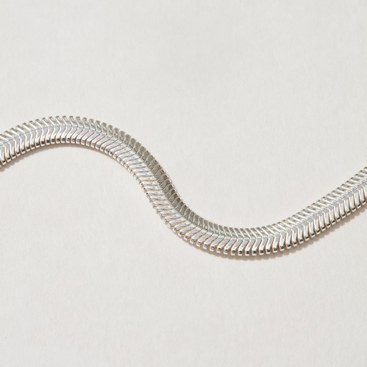 Flat silver herringbone chain, detailed shot showcasing its bold 4.2mm width.