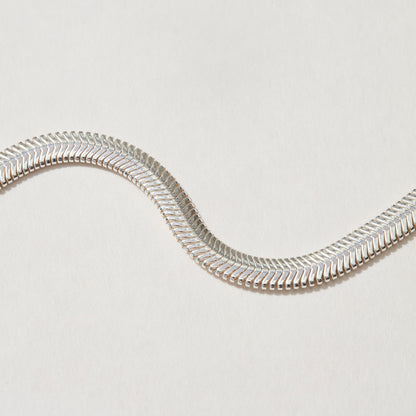 Flat silver herringbone chain, detailed shot showcasing its bold 4.2mm width.