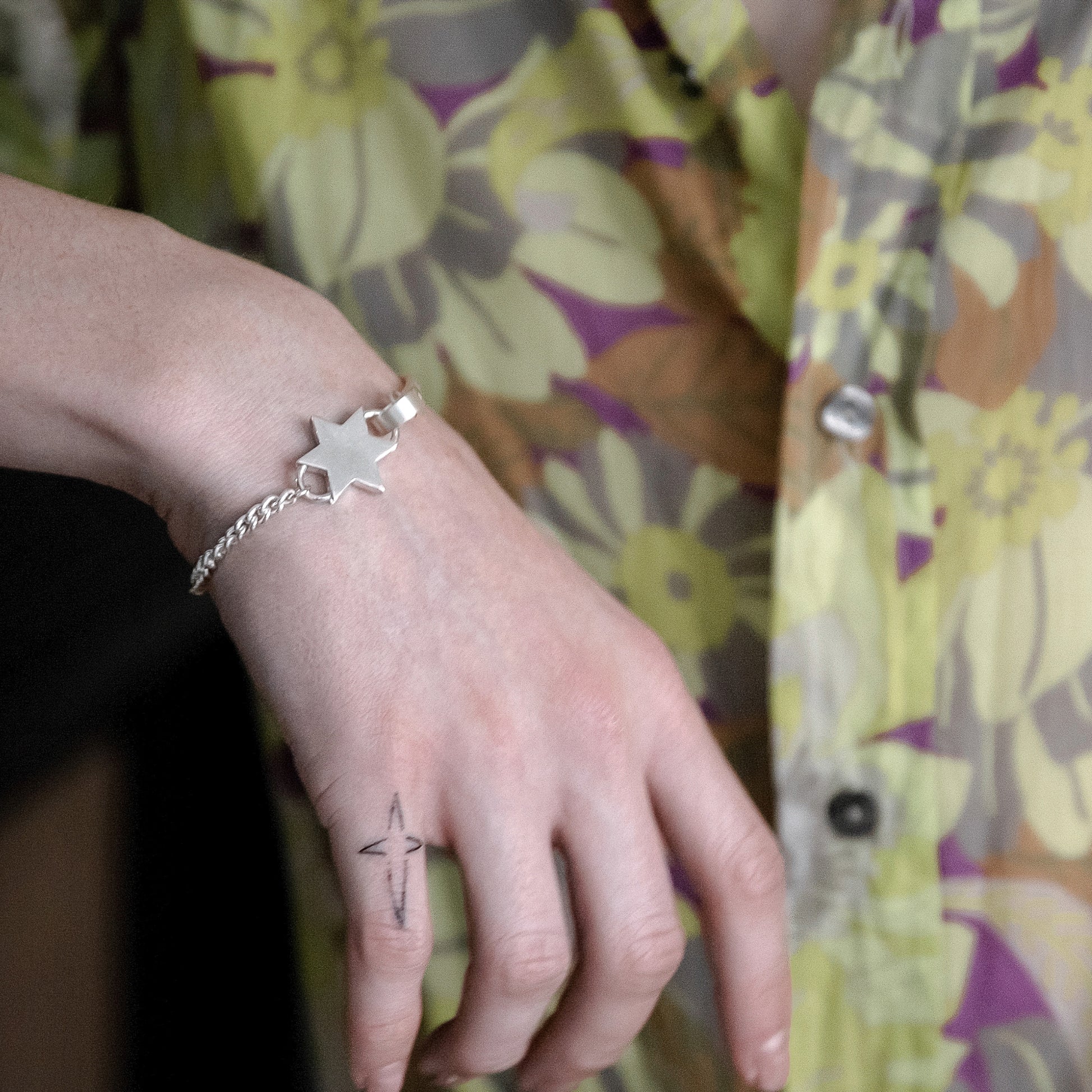 Model wearing a mens sterling silver star bracelet