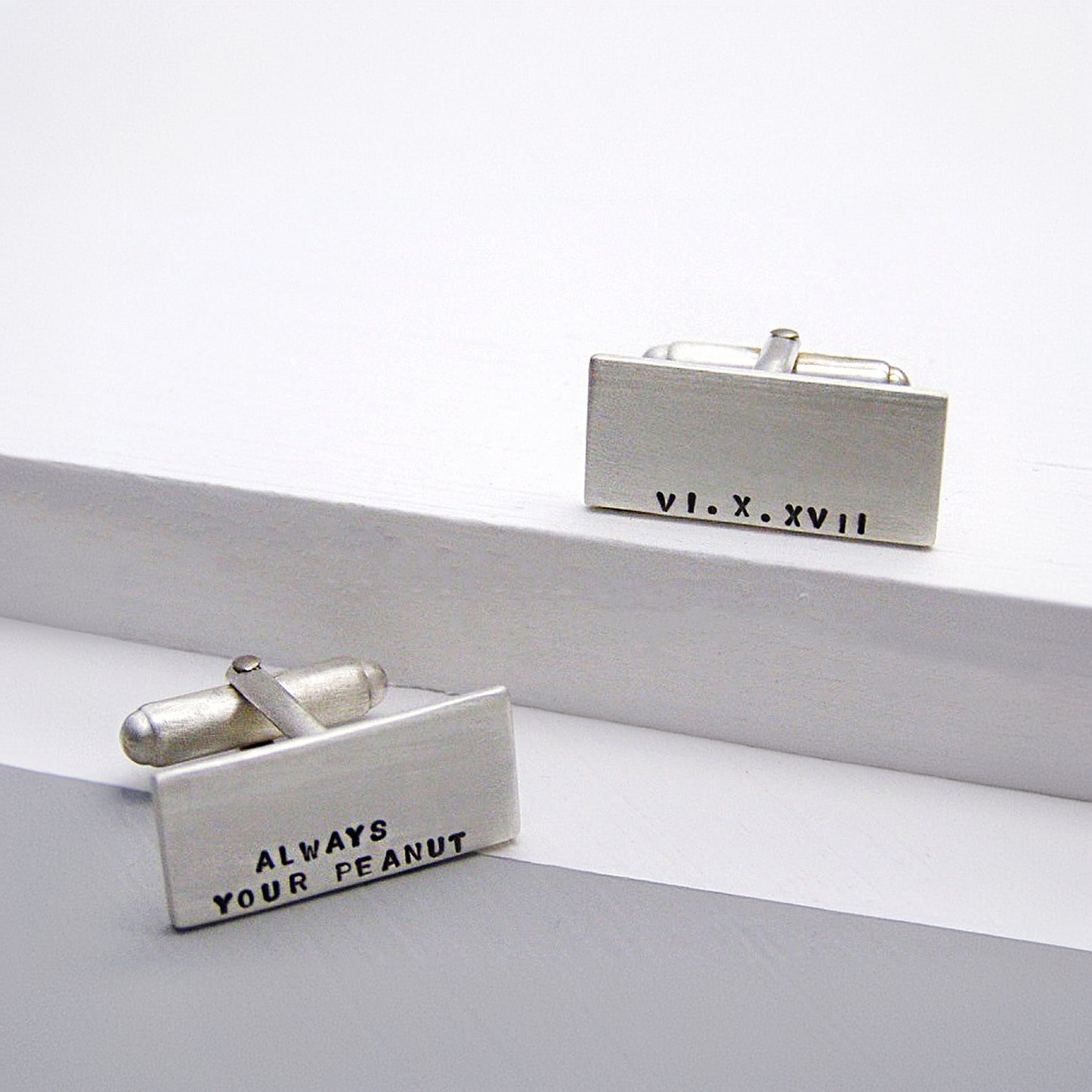 Personalised sterling silver cufflinks with hand-stamped text, brushed matt finish.