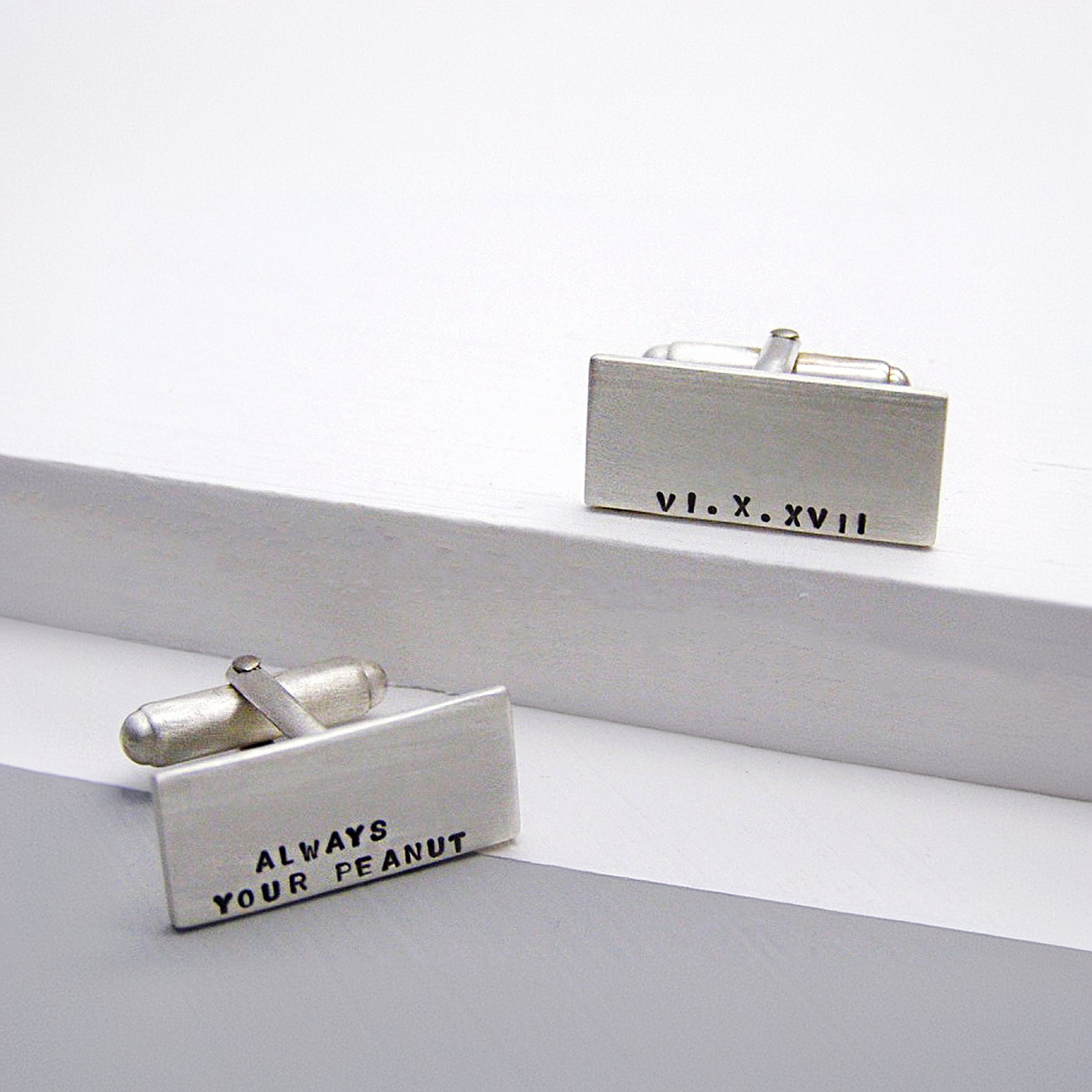 Personalised sterling silver cufflinks with hand-stamped text, brushed matt finish.