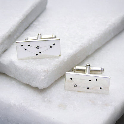 Silver and Diamond Constellation Star Sign Cufflinks on marble.