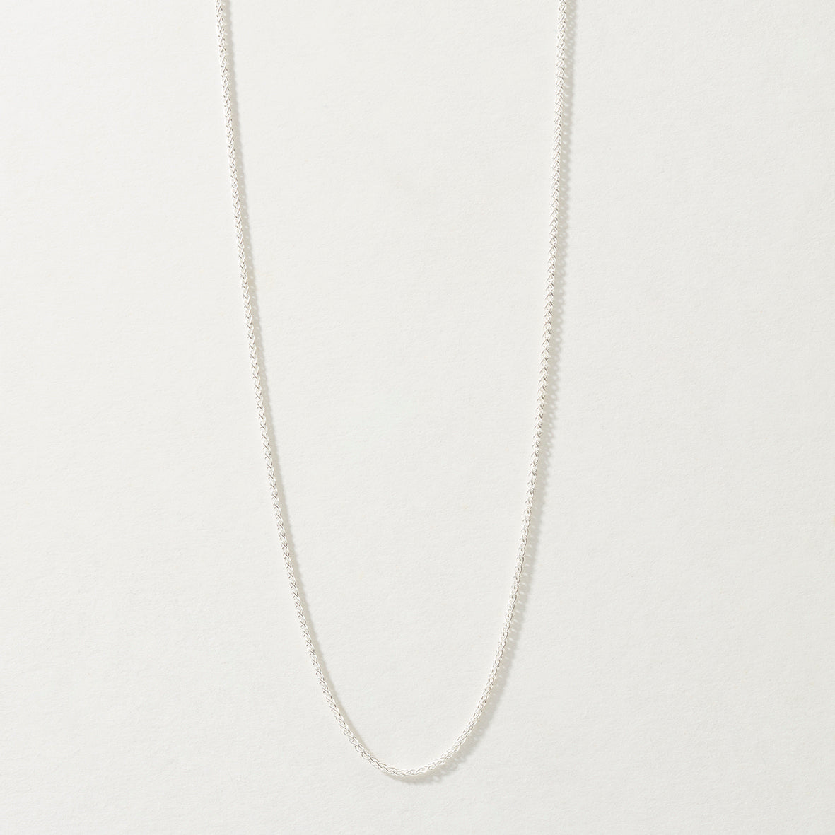 Sterling Silver Spiga Chain Necklace on neutral background.
