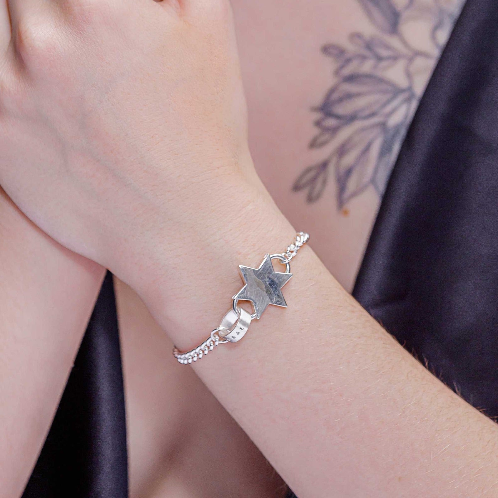 Gorgeous close-up of our chunky silver star charm bracelet with a personalised hoop