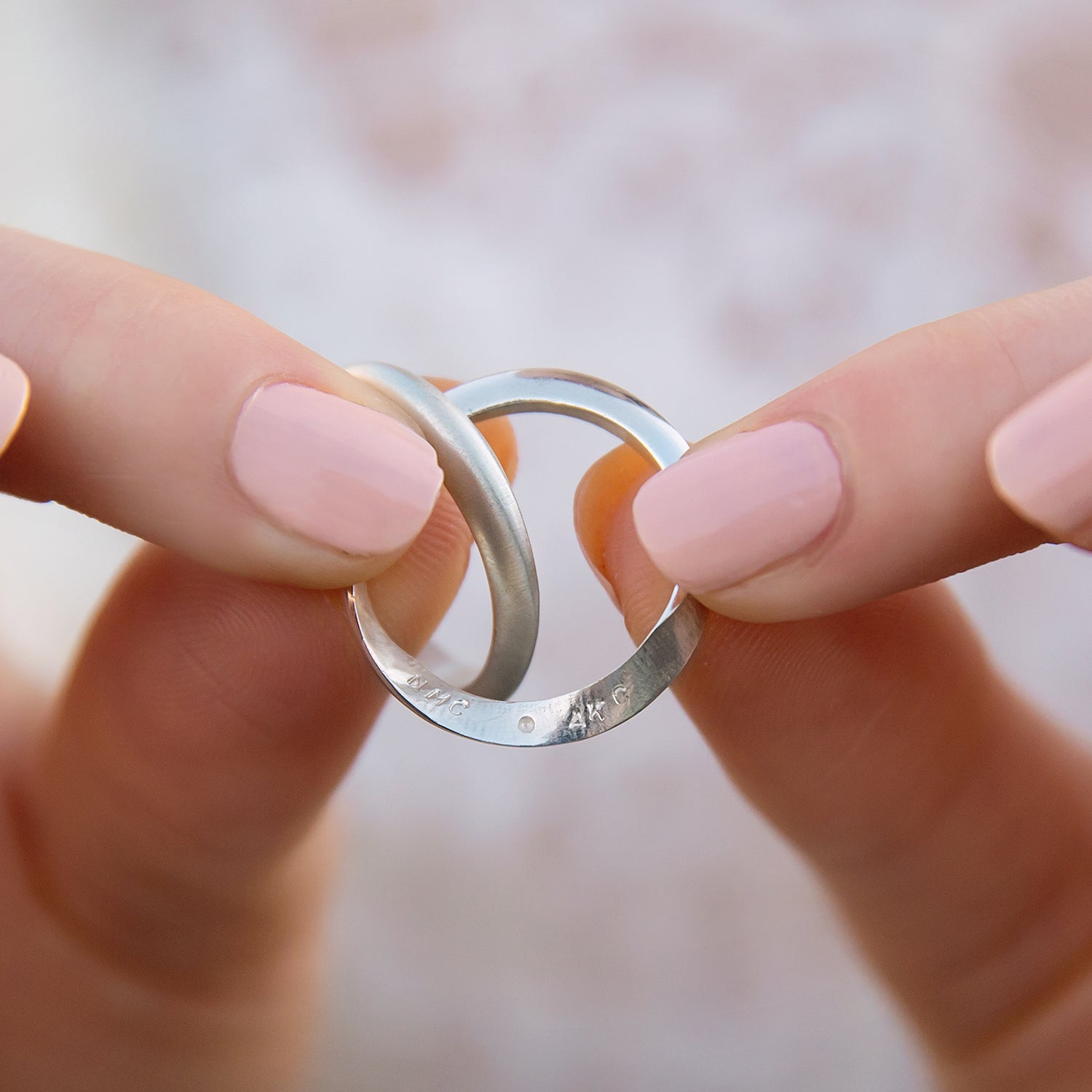 Close-up of silver Mobius ring showing the unique two part design and inside personalisation.